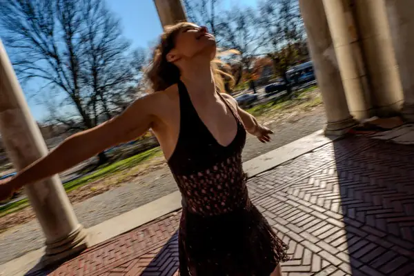 Lucy in dramatic spinning pose with hair flowing and motion blur