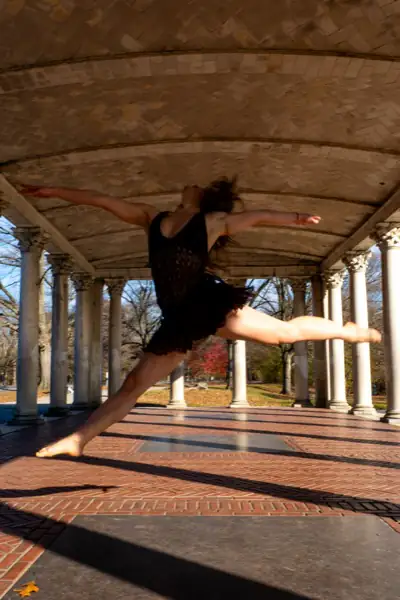 Grand jete leap with arms wide in a stunning display of movement