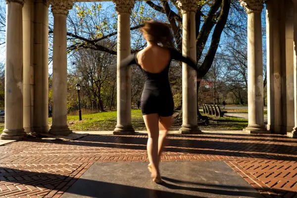 Lucy spinning with hair flying, back view with motion blur