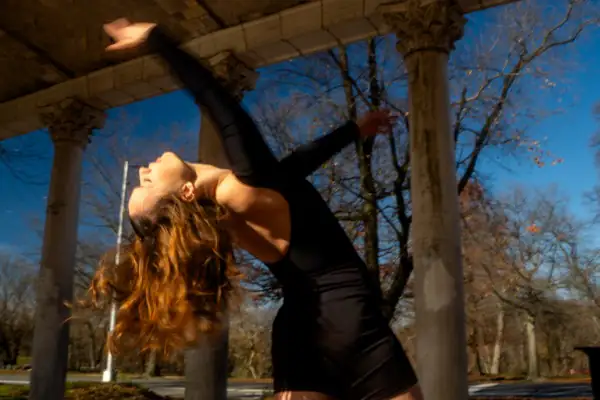 Dramatic backbend with flowing hair, dreamy atmosphere