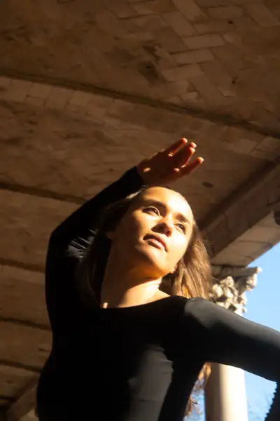Dramatic close-up portrait with hand raised in a powerful gesture