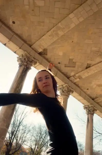 Looking up at camera with architectural ceiling creating dramatic frame