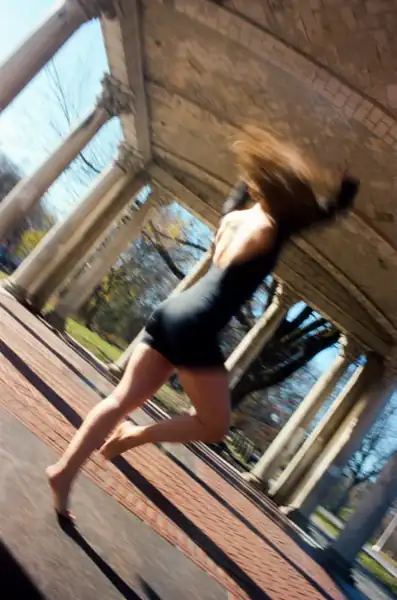 Lucy in full motion blur mid-spin with raw energy