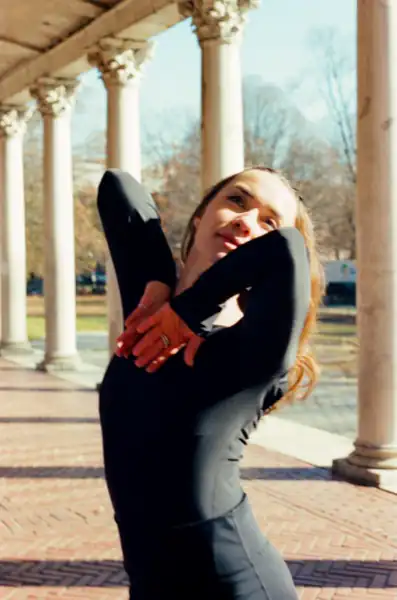 Expressive pose with arms framing face