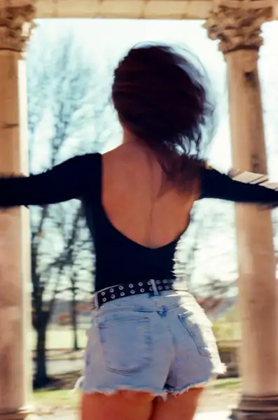 Lucy spinning from behind with hair flowing and arms out