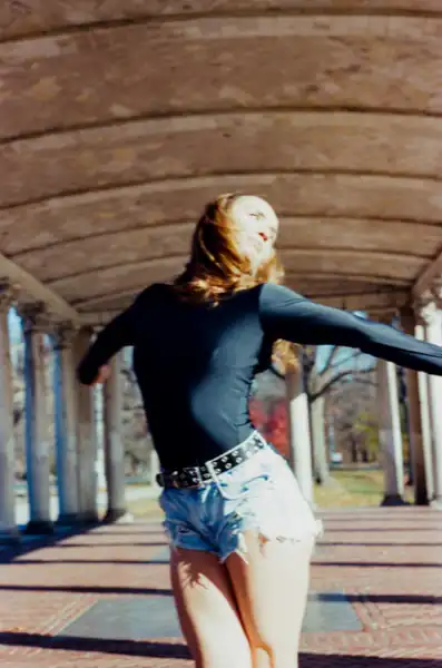 Lucy spinning with arms wide and motion blur