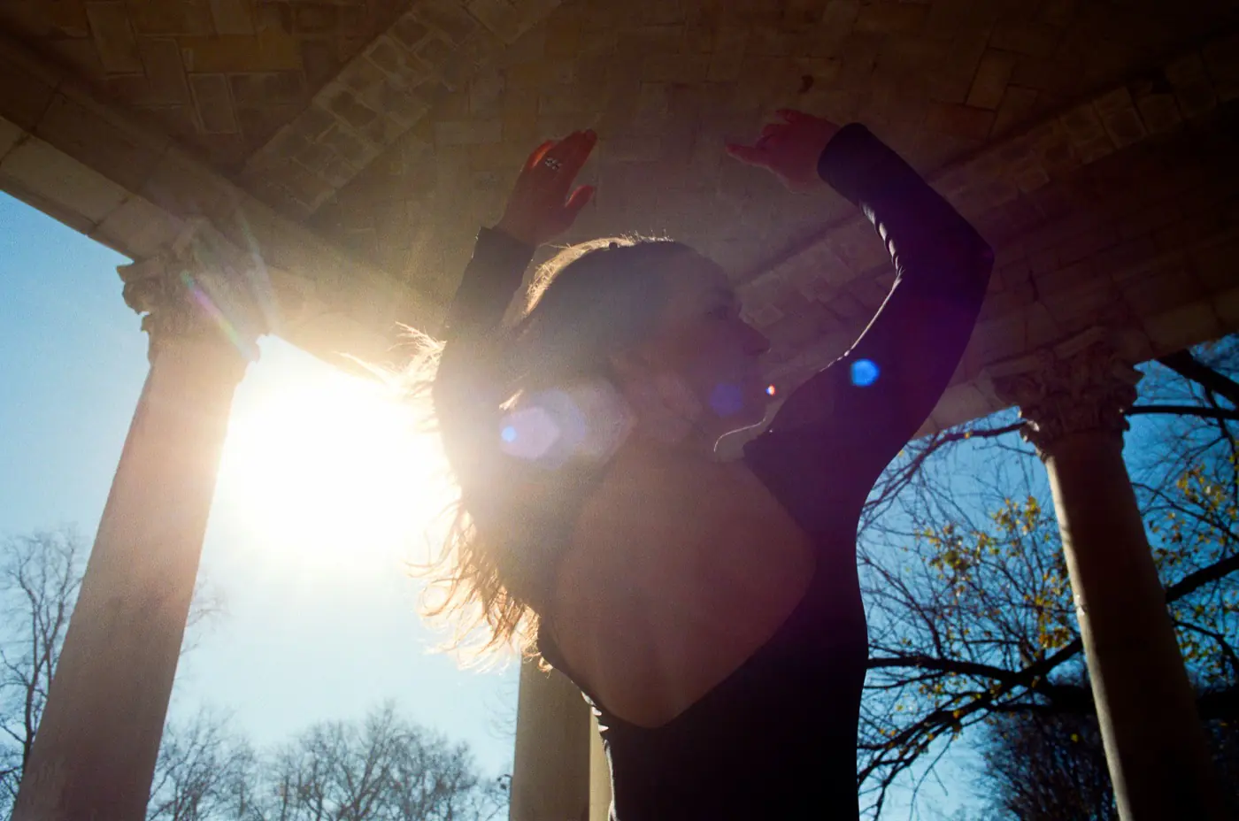 Lucy — ethereal backlit silhouette with lens flare